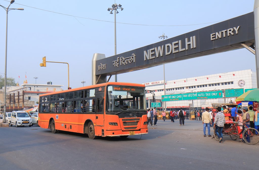 A city cus drops of travelers in front of the New Delhi train station