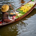 Visit colorful Damnoen Saduak Floating Market just outside of Bangkok