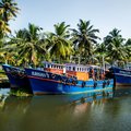 Row of ocean fishing boats in the canals of the Kerala backwaters