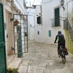 A cyclist in the narrow streets of Puglia