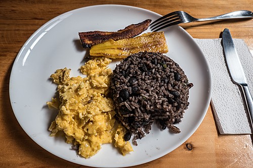 A traditional Costa Rican breakfast with rice, beans, eggs, and plantains