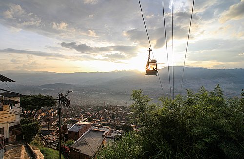 Medellín's cablecar system ascending a hill at dusk