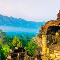 The morning sun washes Borobudur in golden light