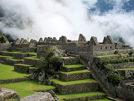 Morning autumn fog enshrouds the Inca ruins of Machu Picchu