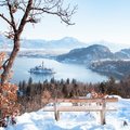 Slovenia's famous Lake Bled in winter with a view of the Julian Alps in the background