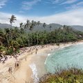 Families enjoy the beach at Parque Nacional Tayrona