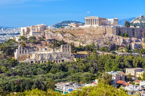 Acropolis hill with famous old Parthenon, top landmark of Athens. Nice landscape of Athens city with classical Greek ruins. Panorama of remains of ancient Athens.