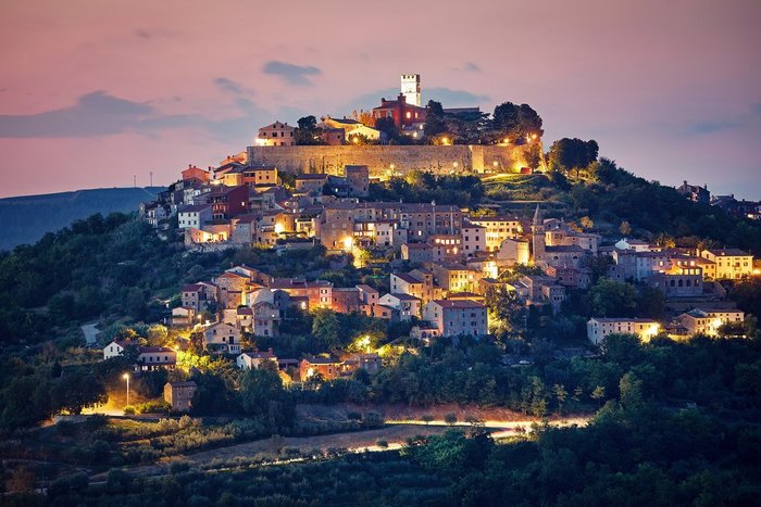 The medieval hilltop town of Motovun lights up at night