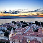 The sun sets over the Adriatic and Zadar's tiled rooftops