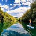 Stand up paddle board along a section of the breathtaking Soča River