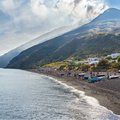 Lie out on the black sand beach of Stromboli Island