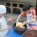 Kids baking a chicken according to a traditional Peruvian recipe 