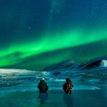 Northern lights dance above the dramatic Icelandic landscape in winter