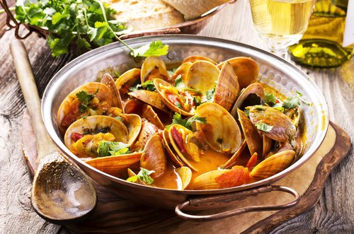 Enjoy delicious plates like this seafood cataplana on a foodie tour of Olhão