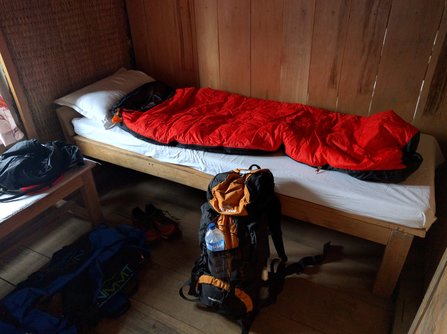 Sleeping bag and backpack in Khopra Danda lodge room