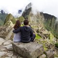 Couple enjoying the views of Machu Picchu citadel 
