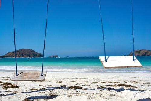 When the sun appears, head to the white sands of Lombok's Kuta beach in May