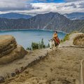 Boy riding a horse at Quilotoa lake in Ecuador