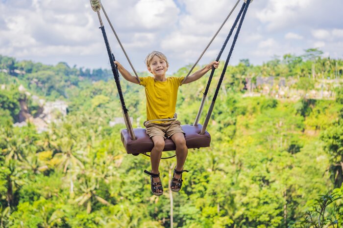 Child swinging over rice fields in Bali