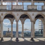  Peer through the arcade of columns over Coimbra from its famous university