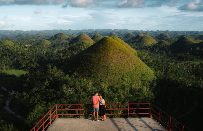 See natural wonders like Bohol's Chocolate Hills as you loop your way through the Philippines from Manila