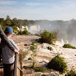 Father and son enjoying the gorgeous view of iguazu falls in argentina