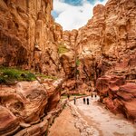 Hike through The Siq to reach the ancient city of Petra