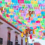 Colorful flags and piñatas on a street in Oaxaca
