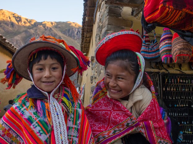 Kids in colorful folk costumes in the Pisac Market, Ollantaytambo