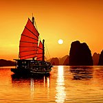 Boats sailing at sunset on Ha Long Bay 