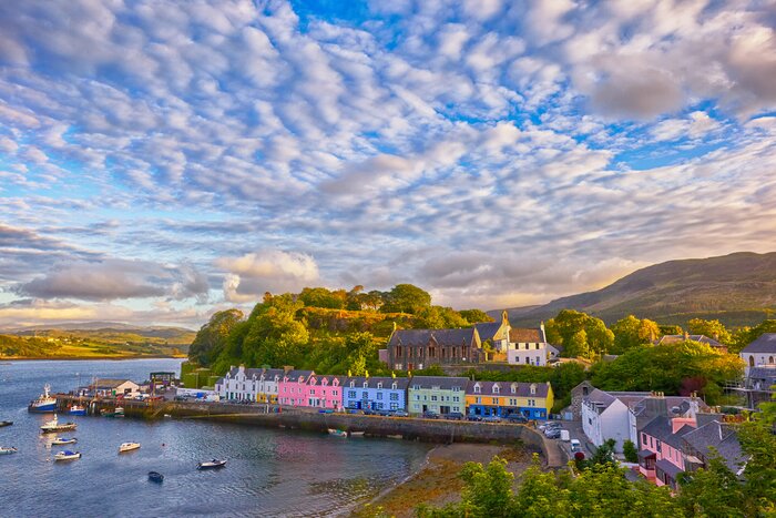 See the colorful houses of Portree on your tour of Scotland