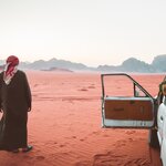 Spend a night in the red deserts of Wadi Rum and explore rock formations and dunes by Jeep