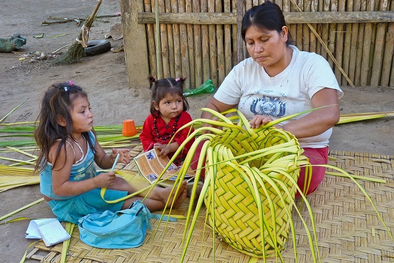 Members of the Moseten tribe weaving baskets.