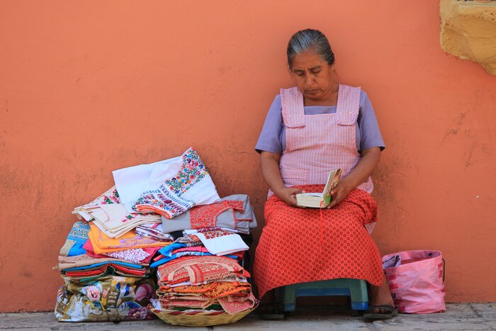 A local vendor and her handmade textiles on the streets of Oaxaca