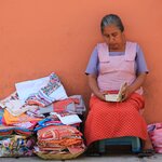 A local vendor and her handmade textiles on the streets of Oaxaca