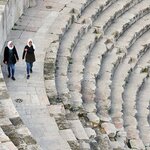 Women walking along the ancient amphitheater of Amman