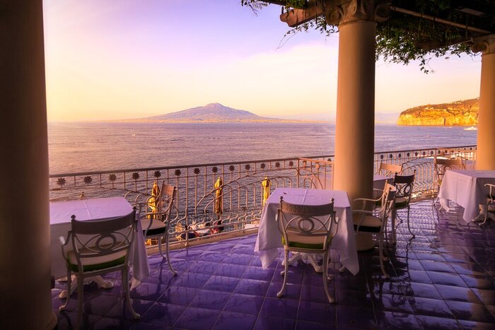 Toast your evening in Sorrento with a view of the Bay of Naples on a one-week luxury tour in Italy