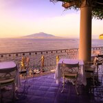 Toast your evening in Sorrento with a view of the Bay of Naples on a one-week luxury tour in Italy
