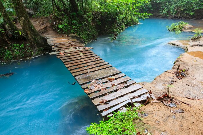 A bridge over the brilliant blue Río Celeste in Tenorio Volcano National Park en route to Arenal