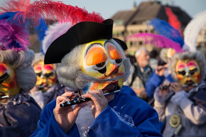 A mischievous "waggis" plays the piccolo in a parade at the Basel Carnival in March