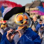 A mischievous "waggis" plays the piccolo in a parade at the Basel Carnival in March