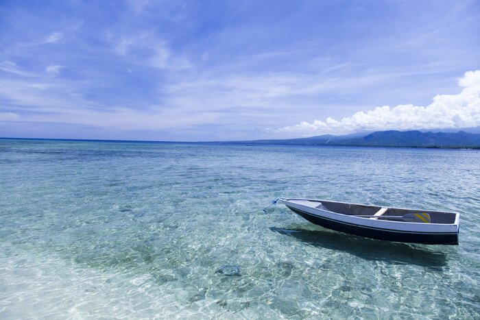 A boat "hovers" on a blue lagoon of Gili Air
