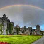 A rainbow hovers above Ashford Castle, a luxury resort near Galway