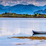 Views to the Isle Ornsay lighthouse from Skye—one of the six Scottish islands you'll visit on this trip