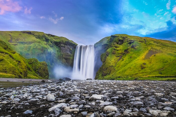 Classic view of famous Skogafoss waterfall in twilight, Golden Circle