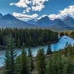 Relish the scenic views like the Rockies, Bow River, and forest (pictured) from your Jasper-Toronto railcar