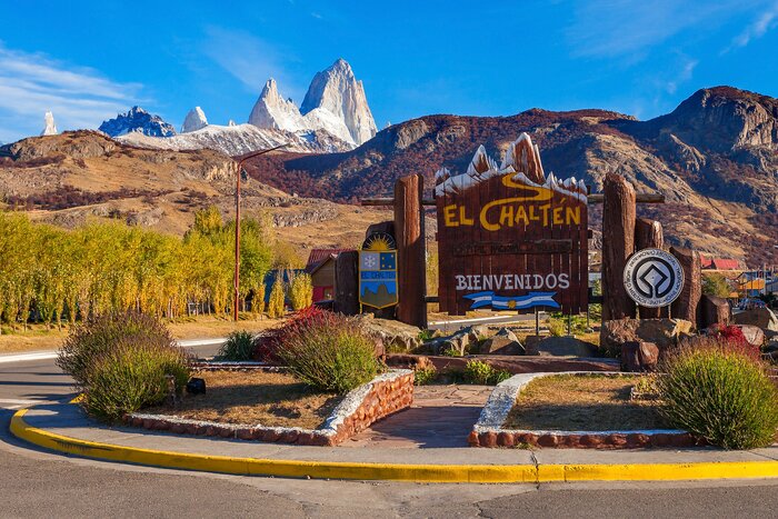 Snap pics in front of the entrance to El Chaltén village with the Fitz Roy mountains in the background