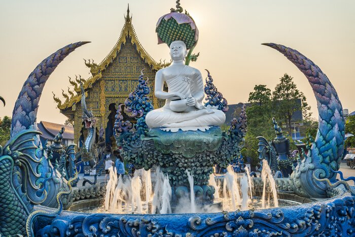 Fly to Chiang Rai from Bangkok where you'll see Wat Rong Suea Ten, also known as the Blue Temple