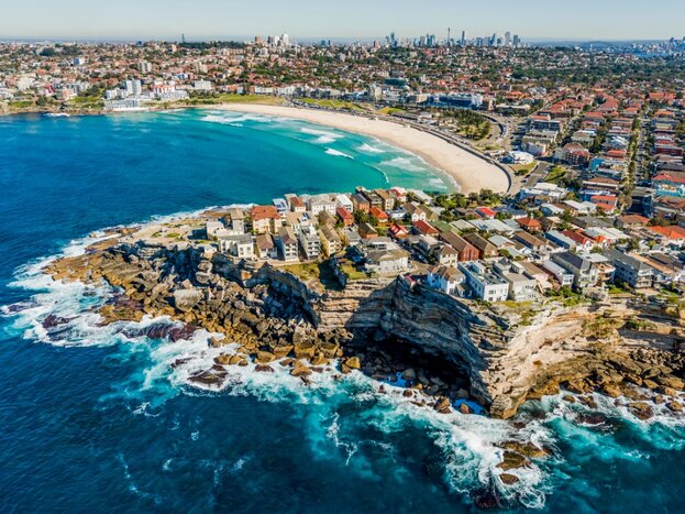 Aerial view of Bondi Beach with Sydney in the background