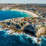 Aerial view of Bondi Beach with Sydney in the background